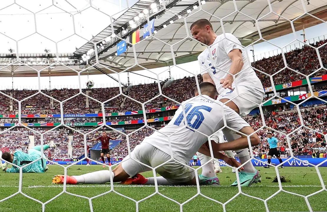 El central eslovaco David Hancko (I) saca bajo la l&iacute;nea un gol junto a su compa&ntilde;ero Denis Vavro durante el partido del grupo E que han jugado B&eacute;lgica y Eslovaquia en Fr&aacute;kfort, Alemania. EFE/EPA/ABEDIN TAHERKENAREH